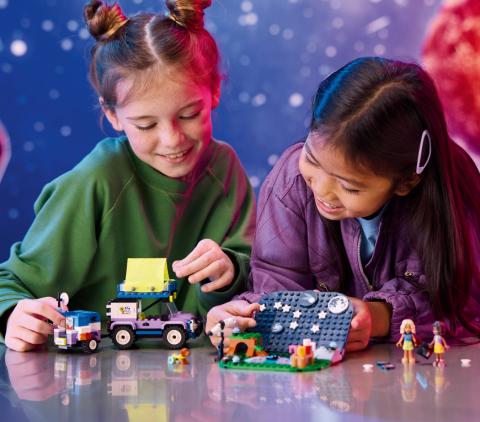 Two girls playing with LEGO®.