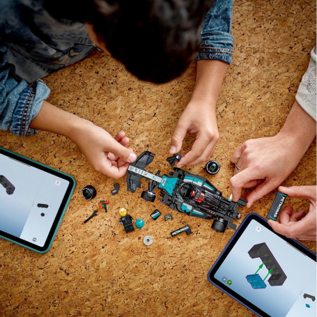 A Mum and son building a LEGO car together.