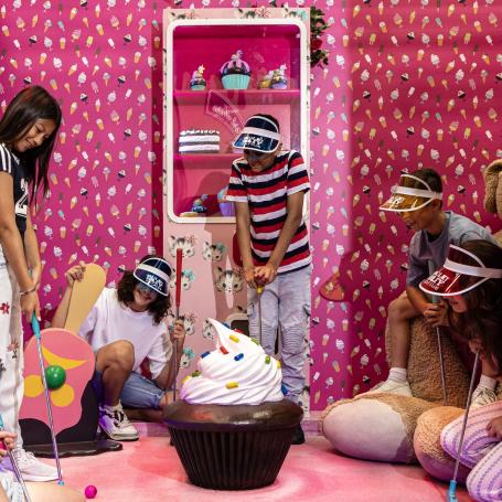 Kids playing mini golf at Holey Moley