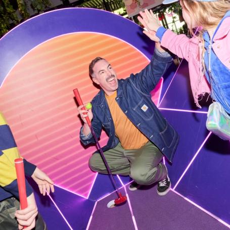 Family playing Holey Moley Mini Golf