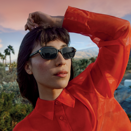 Woman wearing sunglasses from Sunglass Hut