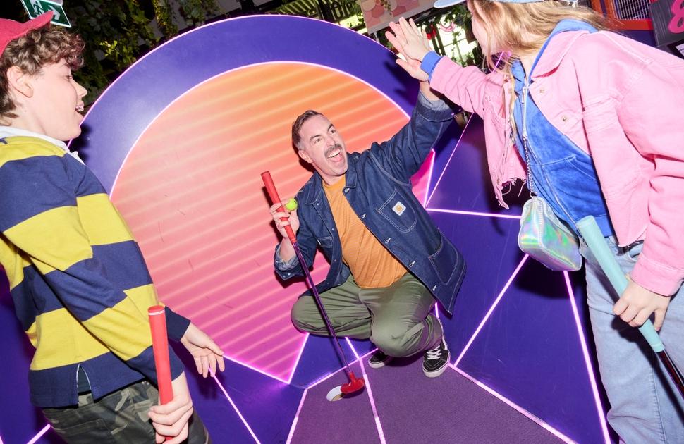Family playing Holey Moley Mini Golf